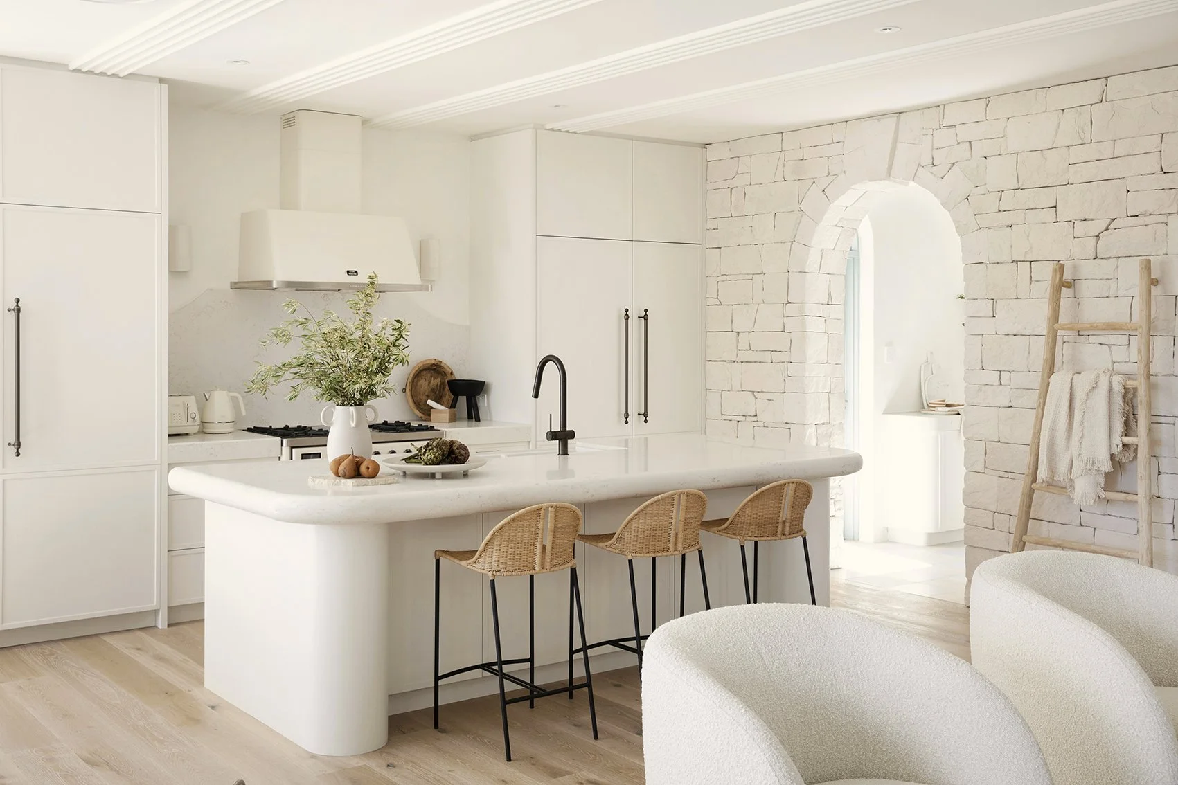 Modern white kitchen renovation with stone arch — Laniworks Construction North Vancouver